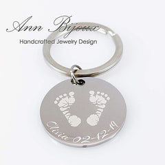 Custom footprint engraved silver keychain. Personalized baby footprint jewelry with name and birthdate detail, showcasing the transformation from an ink print to a metal engraving.