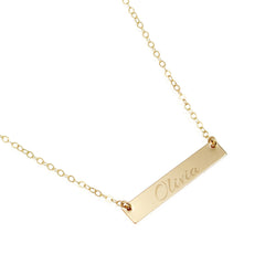 Gold necklace with a bar pendant engraved with 'Olivia' on a white background