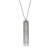 A stainless steel necklace with a cross pendant featuring a engraved text on it, attached to a chain.