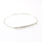 Personalized silver bar bracelet engraved with custom GPS coordinates. A minimalist dainty chain bracelet for women, perfect for commemorating a special location or travel memory.