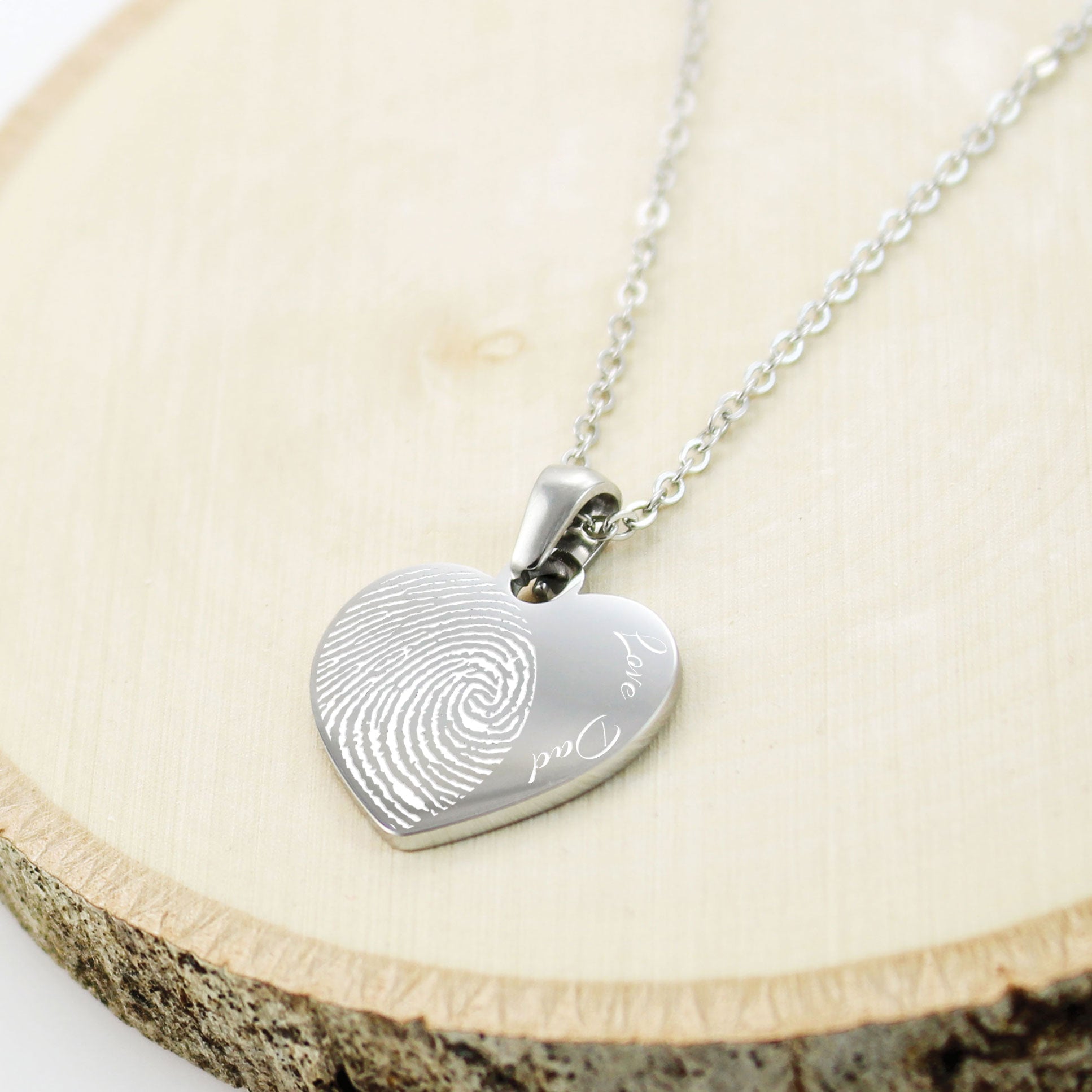 "Personalized memorial heart necklaces featuring actual fingerprints and custom handwritten messages.