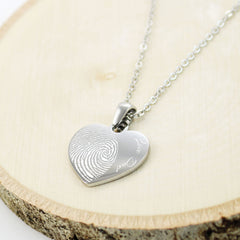 "Personalized memorial heart necklaces featuring actual fingerprints and custom handwritten messages.