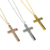 Three cross necklaces in gold, silver, and rose gold on a white background