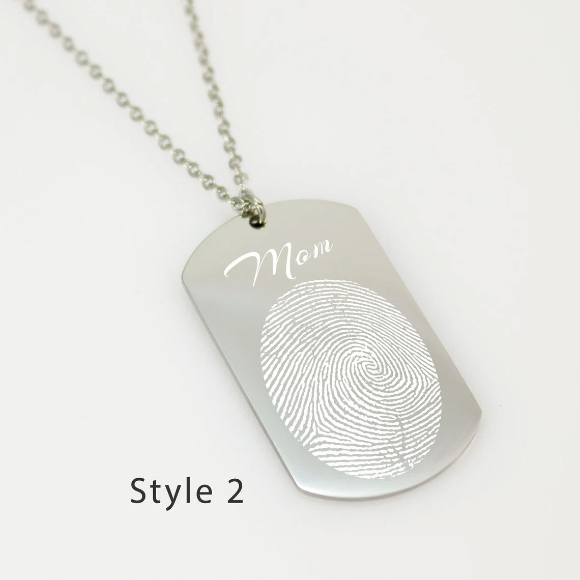 "Personalized men's fingerprint dog tag pendant. A sentimental jewelry piece featuring a unique life-sized fingerprint engraving on a durable silver-tone metal tag."