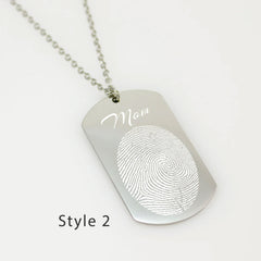 "Personalized men's fingerprint dog tag pendant. A sentimental jewelry piece featuring a unique life-sized fingerprint engraving on a durable silver-tone metal tag."
