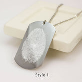 "Custom fingerprint dog tag necklace in a brushed silver finish. A high-definition actual thumbprint is laser-engraved onto a vertical rectangular pendant with curved edges, labeled as Style 1."