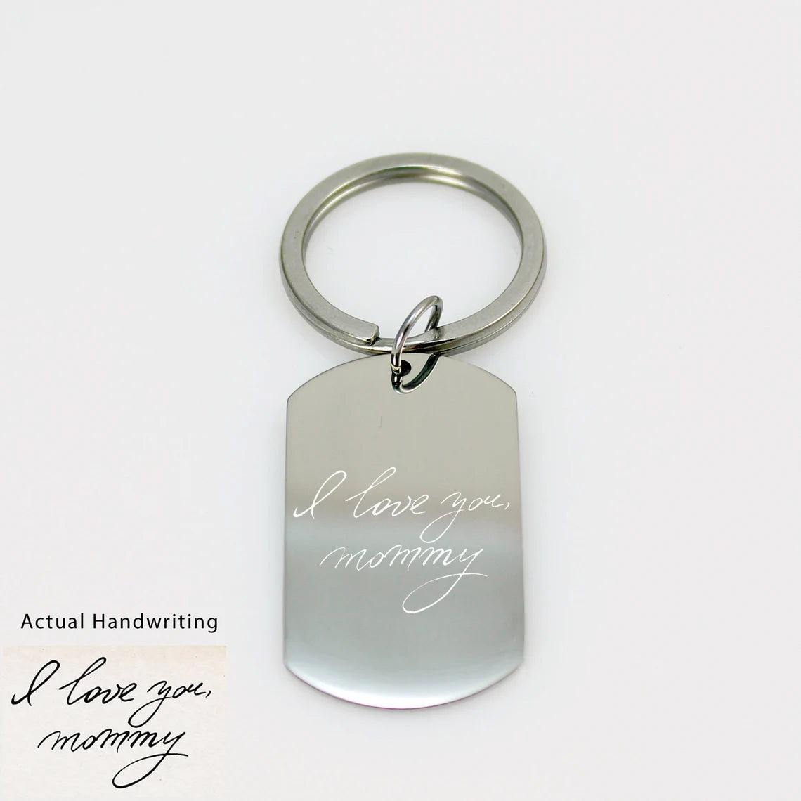 Custom silver dog tag keychain engraved with a detailed white fingerprint on a polished metal surface.