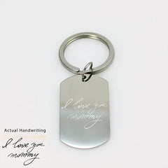 Custom silver dog tag keychain engraved with a detailed white fingerprint on a polished metal surface.