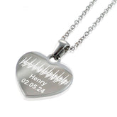 "Silver heart pendant necklace featuring a custom engraved soundwave pattern. The personalized jewelry includes the name 'Henry' and a date '02.05.24' etched below the unique audio wave design."