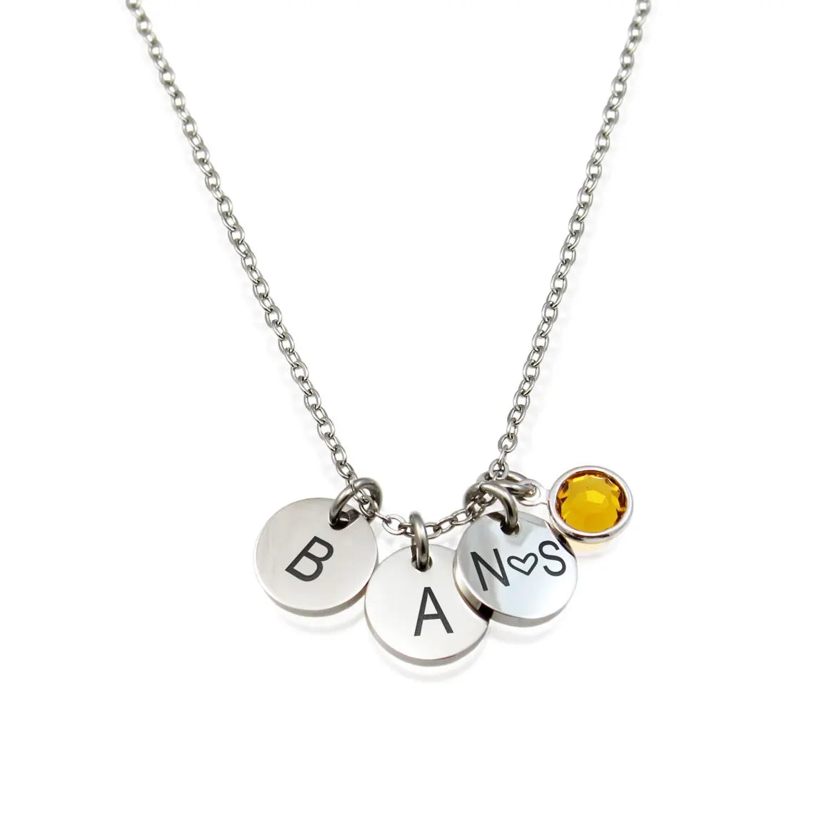 Personalized silver initial necklace featuring a round disc engraved with a script letter B and a yellow citrine birthstone charm.