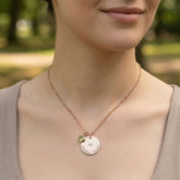 Necklace with a heart-shaped pendant worn by a person outdoors