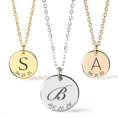 Three personalized round pendant necklaces on chains, shown against a clean white background. The left necklace has a gold chain and a gold pendant engraved with the letter S and a date.