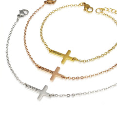 Set of four gold and silver cross-shaped bracelets on a white background