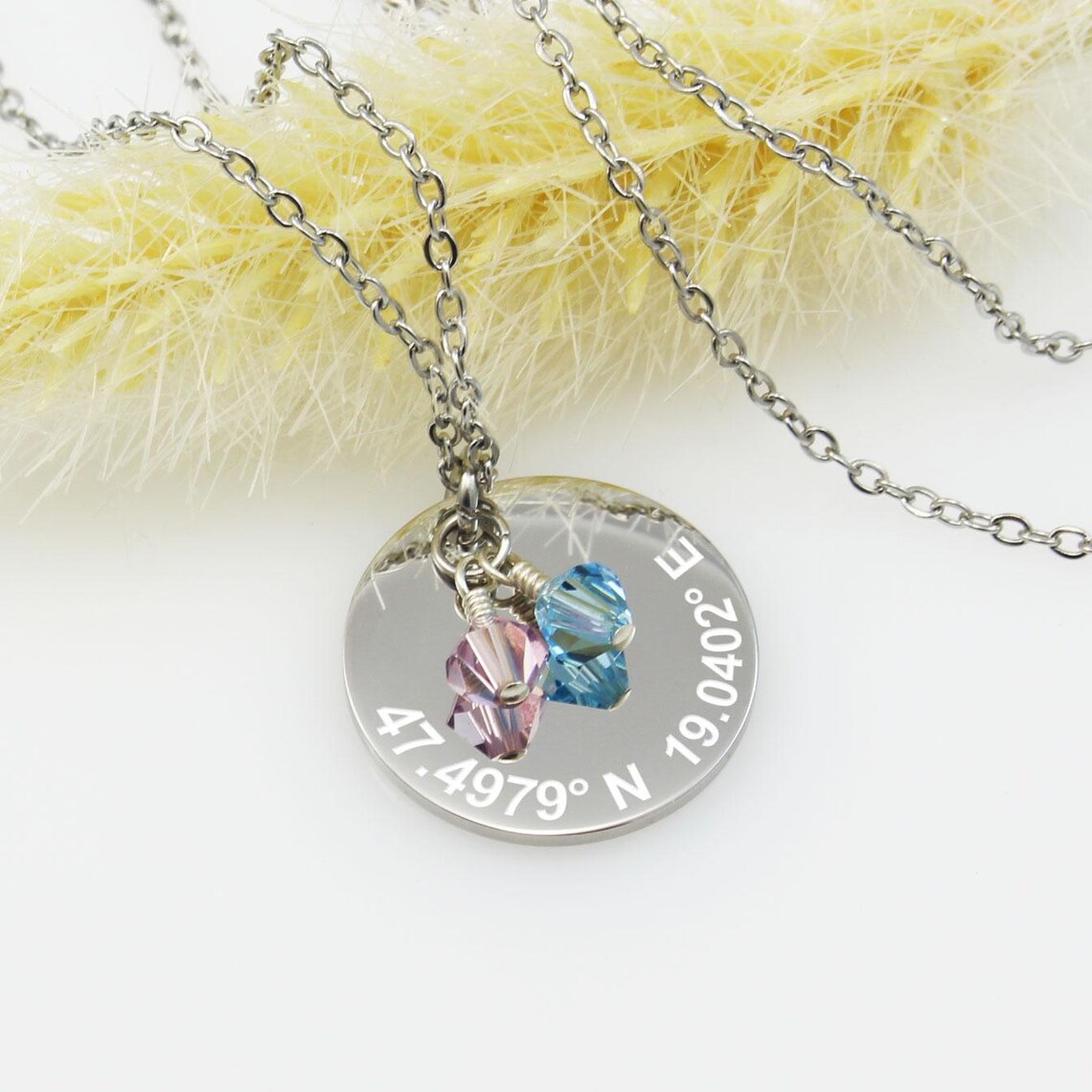 Silver disc coordinates necklace with birthstone crystal charms on a cable chain.