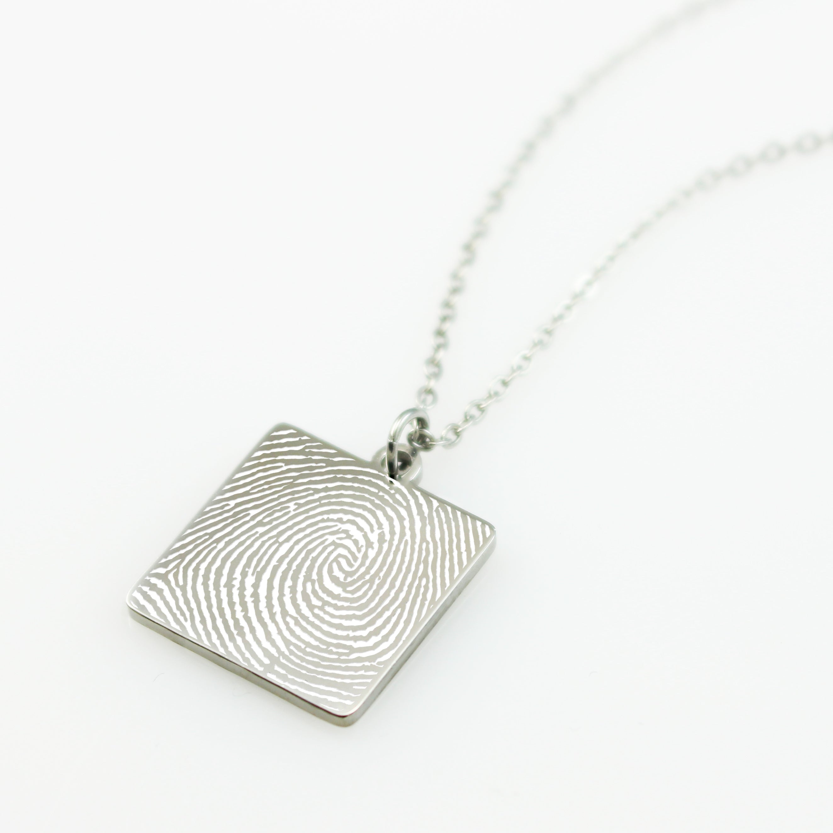 silver color fingerprint necklace on white back ground