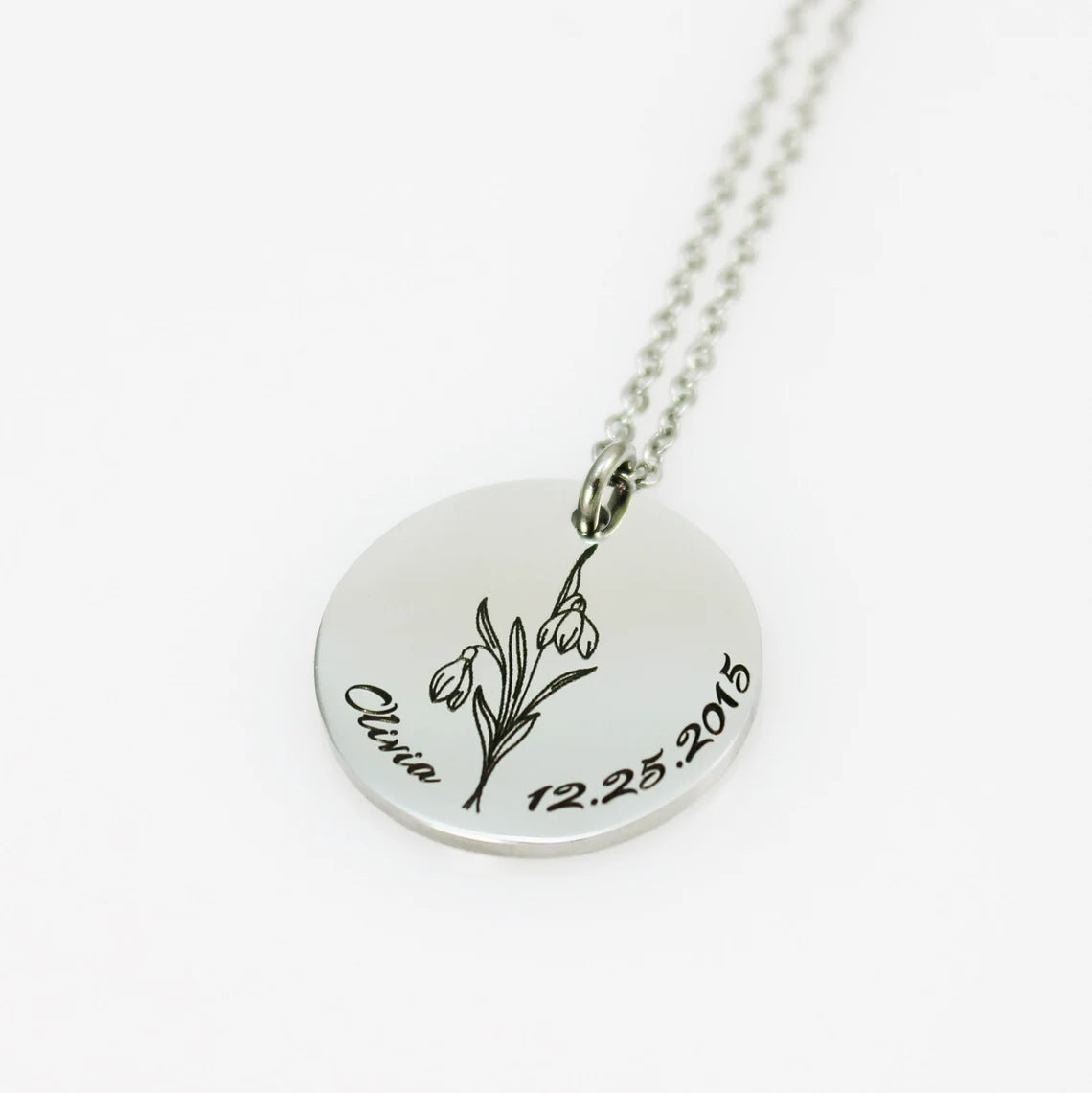 "Silver heart necklace with custom fingerprint engraving on a delicate cable chain."