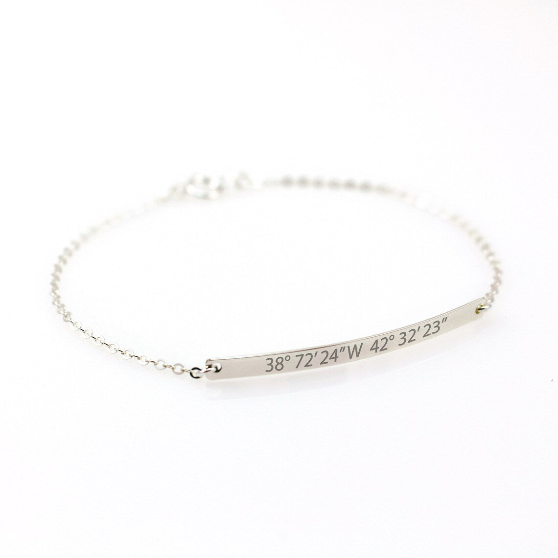 Personalized silver bar bracelet engraved with custom GPS coordinates. A minimalist dainty chain bracelet for women, perfect for commemorating a special location or travel memory.
