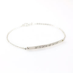 Personalized silver bar bracelet engraved with custom GPS coordinates. A minimalist dainty chain bracelet for women, perfect for commemorating a special location or travel memory.