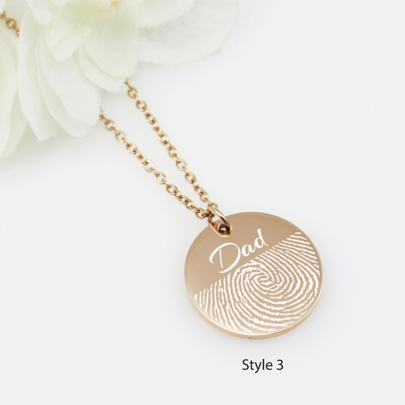 "Silver disc necklaces with custom engraving of handwritten messages and drawings in a white gift box."