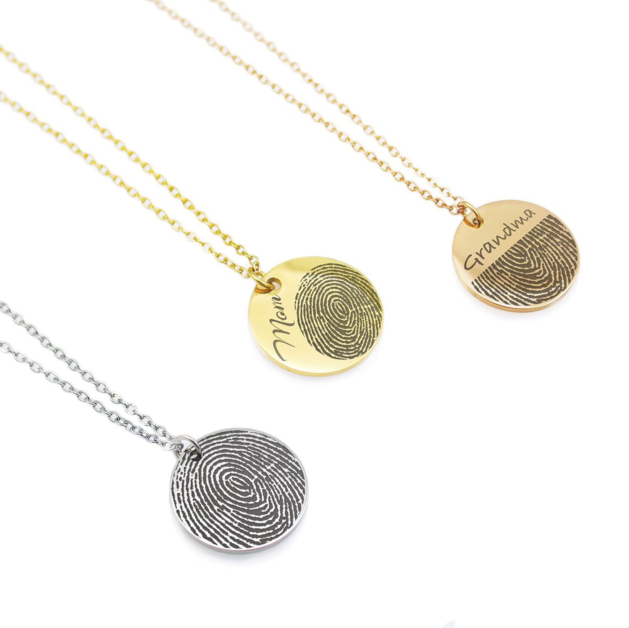 Three round disc necklaces in silver, gold, and rose gold finishes. Each pendant features a high-detail fingerprint engraving. The gold and rose gold discs also include custom name engravings—'Mom' and 'Grandma'—in a delicate cursive script.