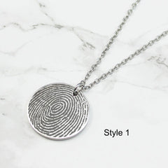 Personalized fingerprint engraved disc necklaces in silver, gold, and rose gold with custom name engravings for Mom and Grandma.