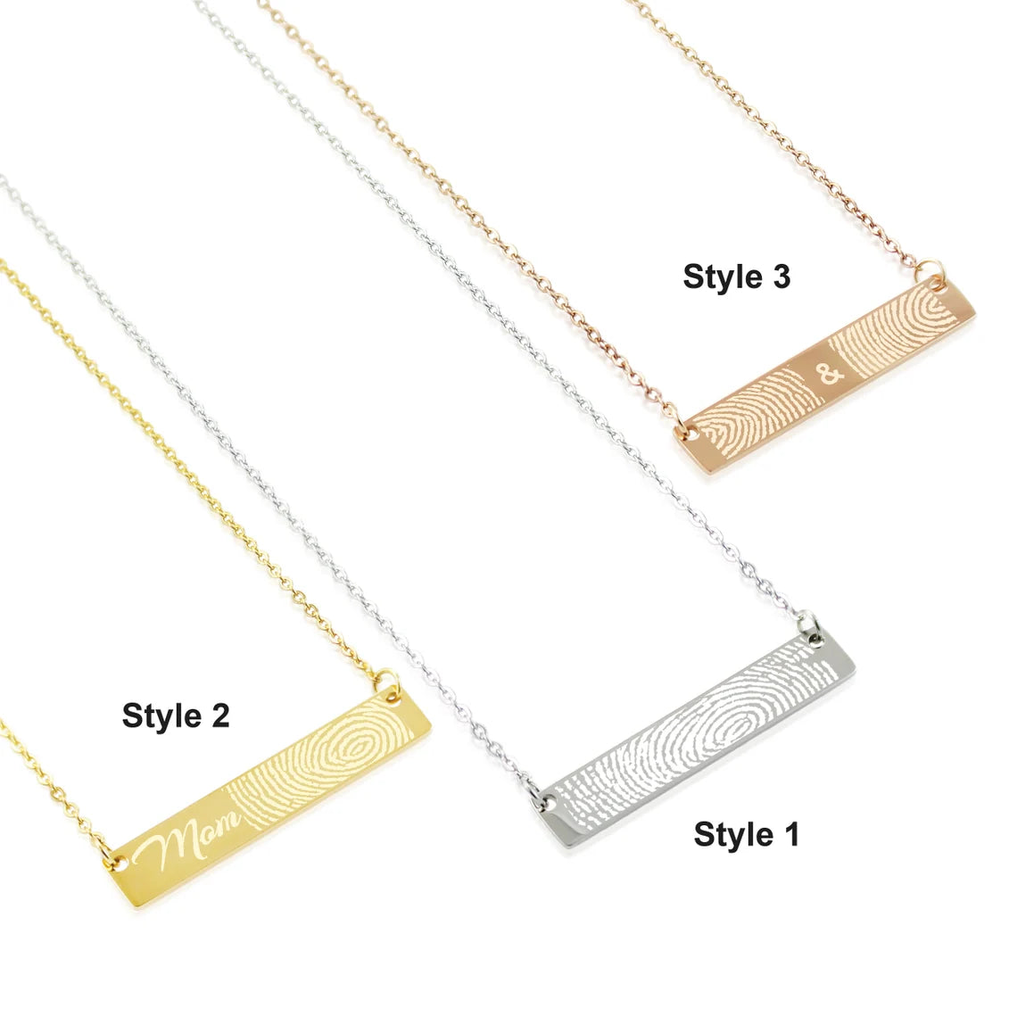 Three stainless steel fingerprint bar necklaces in gold, silver, and rose gold colors, each with a different pattern on the bar pendant.