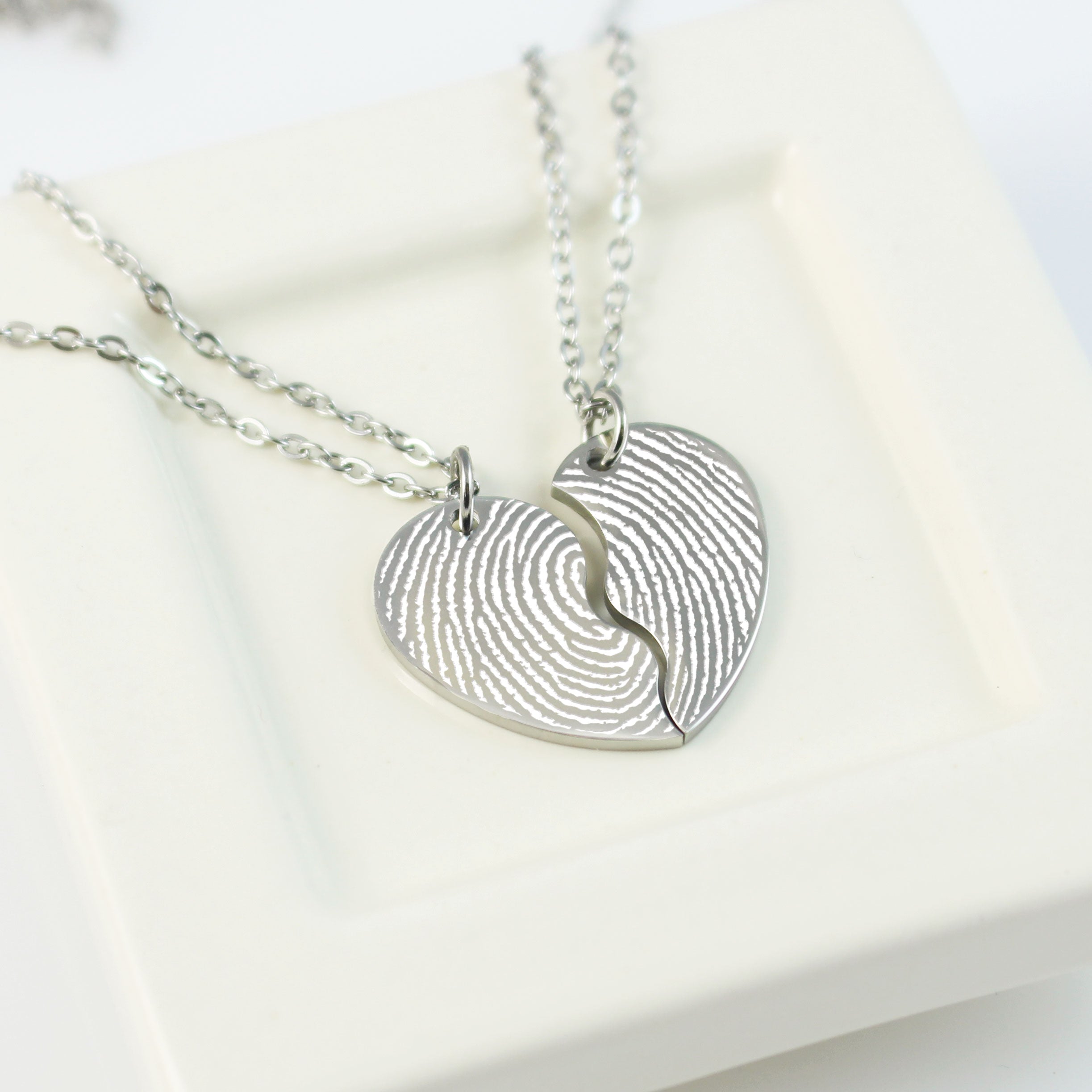 Silver fingerprint necklace on a white background
