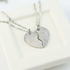 Silver fingerprint necklace on a white background
