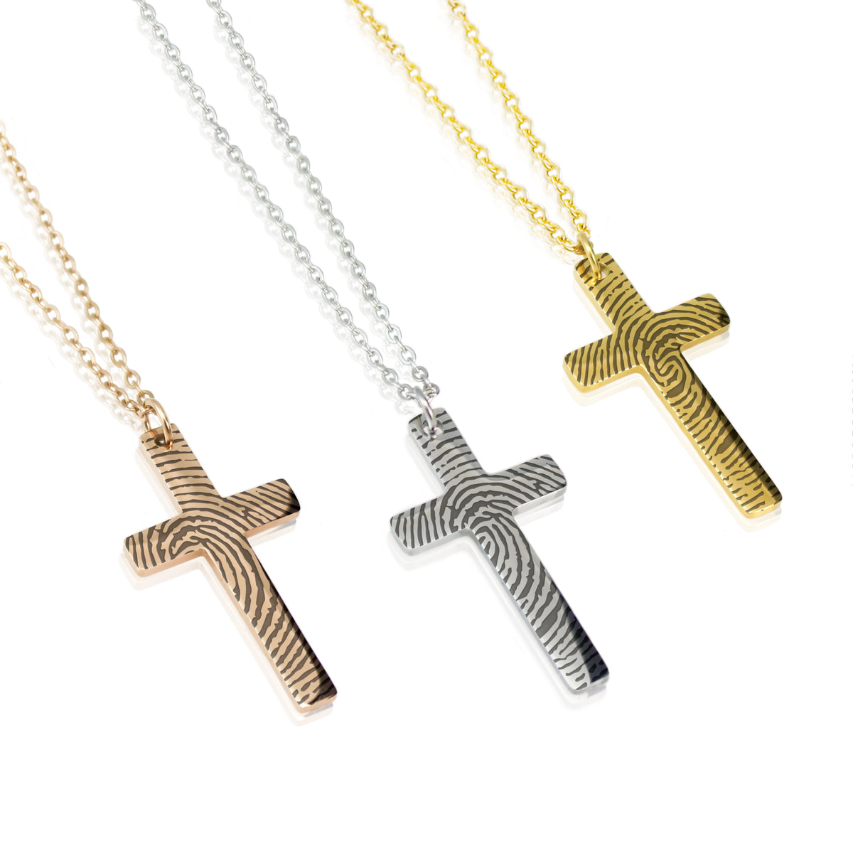 Three cross necklaces in gold, silver, and rose gold on a white background