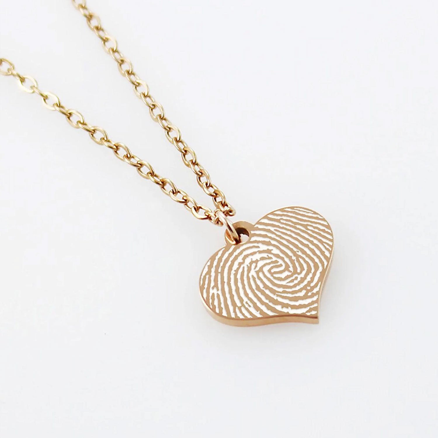 "Personalized fingerprint heart necklace in silver, a unique memorial or sentimental gift featuring the actual thumbprint of a loved one engraved on a heart pendant."
