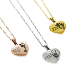 Heart-shaped pendants with engraved footprints and text on a white background