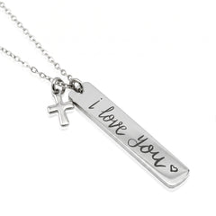 A silver necklace featuring a rectangular bar pendant engraved with 'i love you' and a small hanging cross charm, shown on a plain white background.