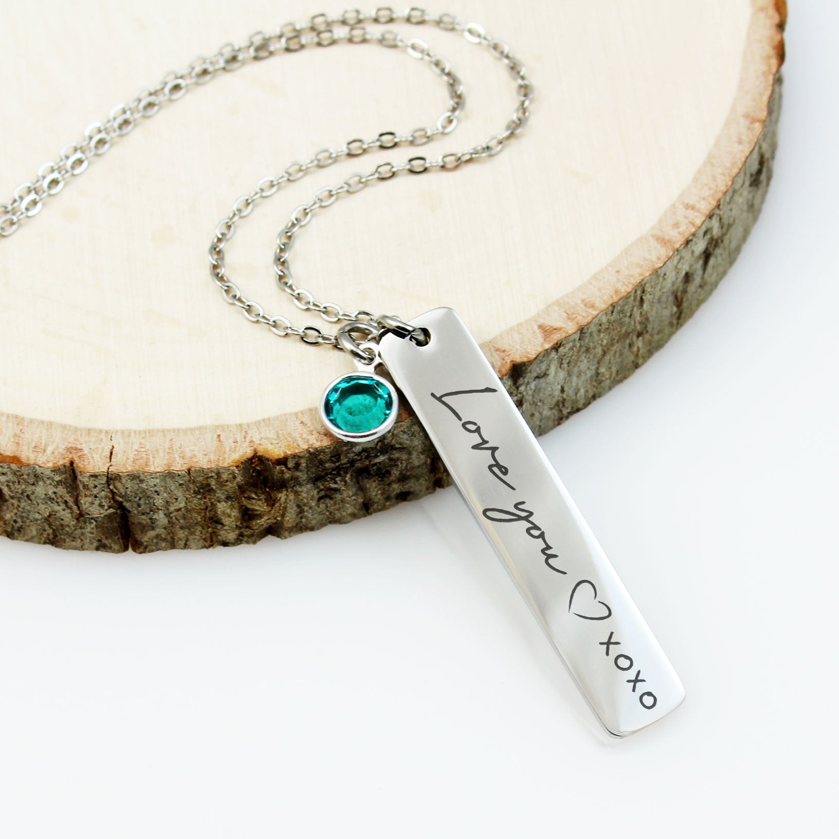 "Silver family name necklaces with birthstones on delicate chains."