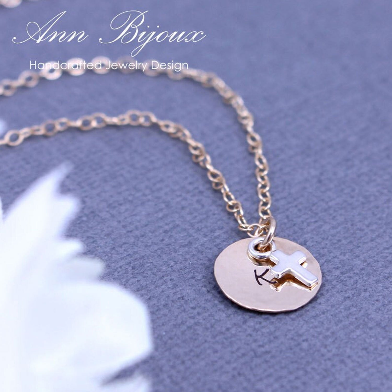 Gold necklace with a round pendant featuring a star design on a blue background.