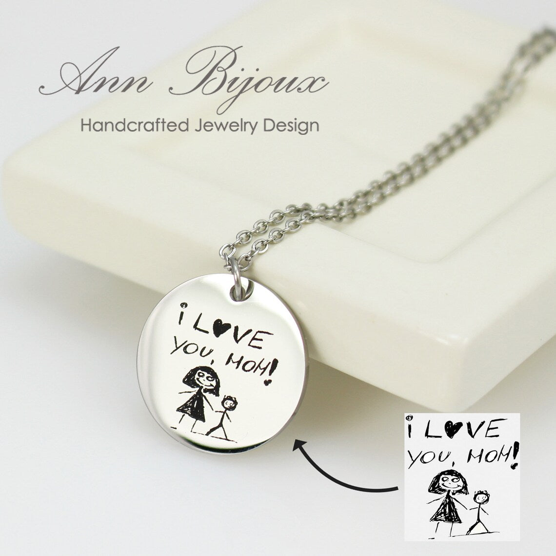 The silver pendant is engraved with a child's drawing and "I love you, Mom"