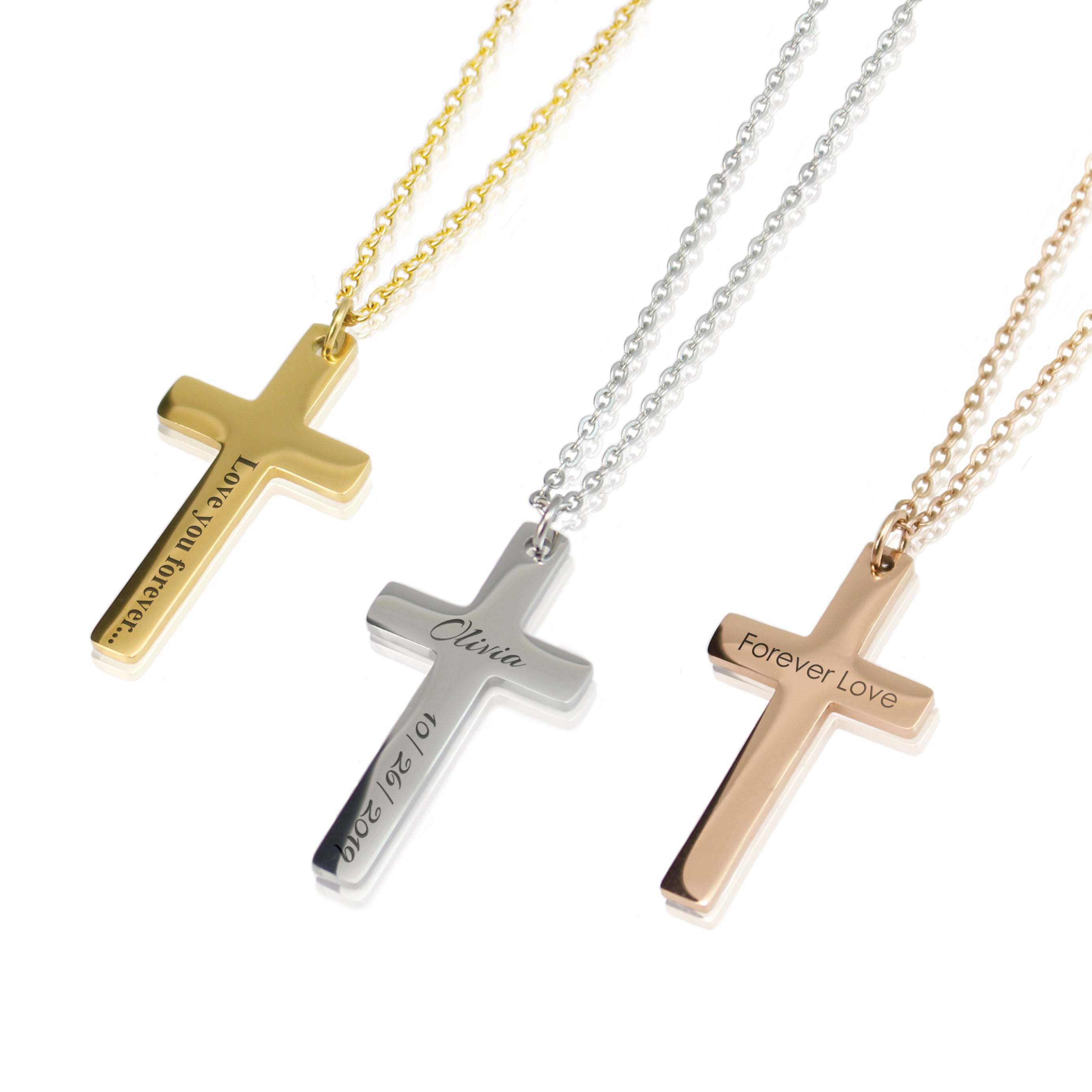 Three cross-shaped necklaces in gold, silver, and rose gold on a white background.