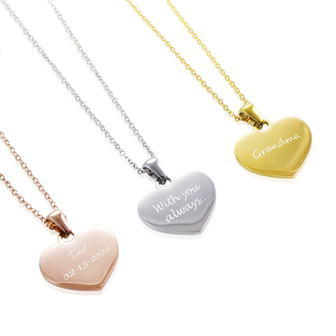 Personalized heart pendants engraved with unique message, shown in a trio of polished yellow gold, sterling silver, and rose gold.