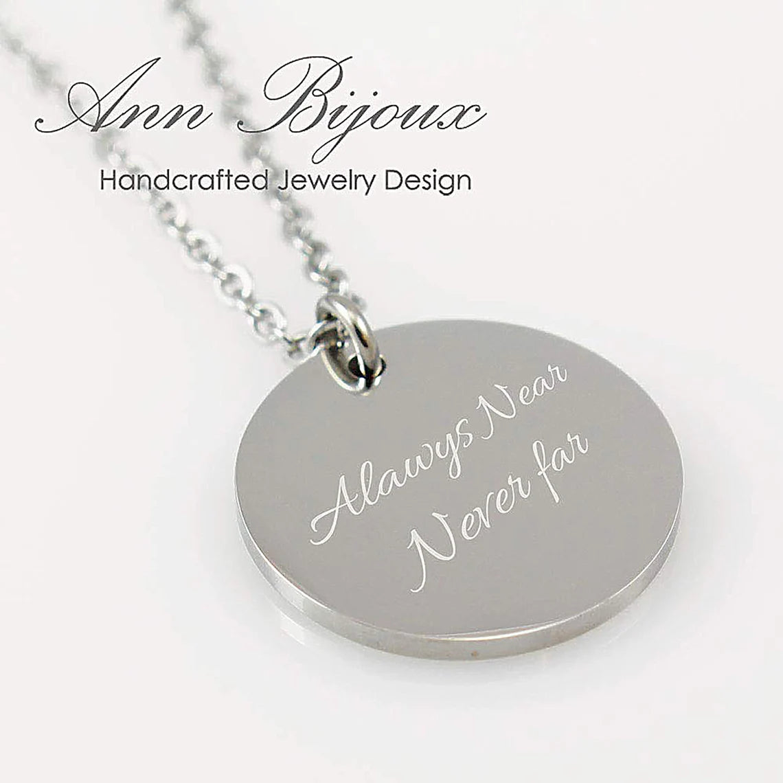 "Silver disc necklace with custom baby footprint and name engraving."