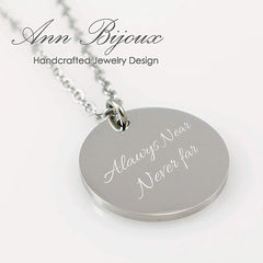"Silver disc necklace with custom baby footprint and name engraving."