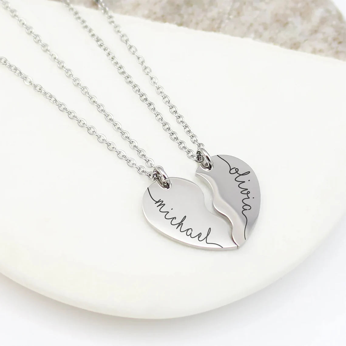 Includes two separate pendants that fit together like a puzzle, representing two halves of a whole.