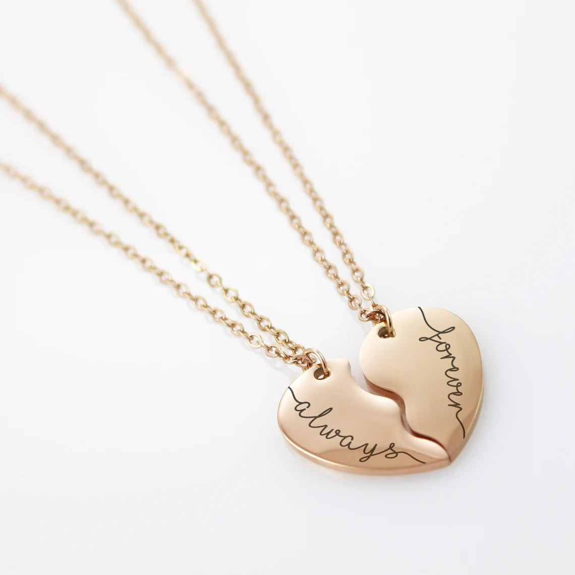A delicate engraved line connects the names, symbolizing an unbreakable bond between the two wearers.