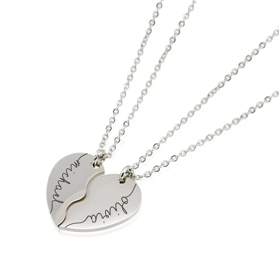 Each half is precision-engraved with a name or word in a beautiful, flowing signature-style font.