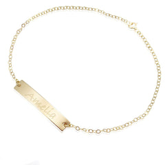 Gold bracelet with a bar pendant engraved with 'Amelia' on a white background