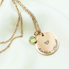 This Personalized Birthstone Name Disc Necklace is a timeless piece designed to keep your most precious connections close to your heart. 