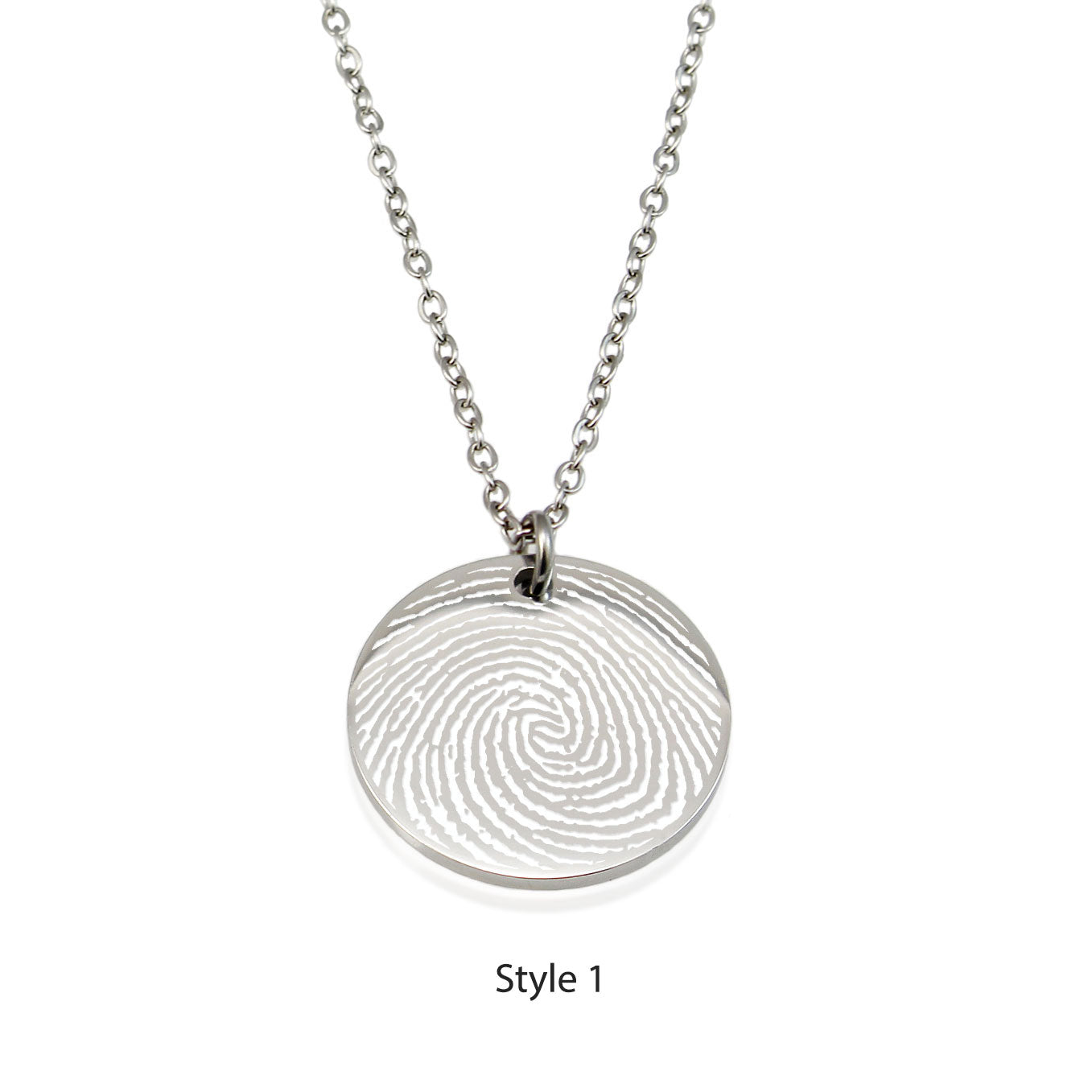 "Personalized handwriting jewelry in silver. Heartfelt messages like 'Always in my heart' and unique family drawings are engraved onto polished round pendants. Presented in a signature white gift box."