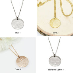 "Two custom silver disc necklaces. One features an intricate engraved line drawing of 'Pia' and the text 'by Max' in a child's handwriting. The other shows only the handwritten message 'Always in my heart'. Both are shown in their open jewelry gift box."